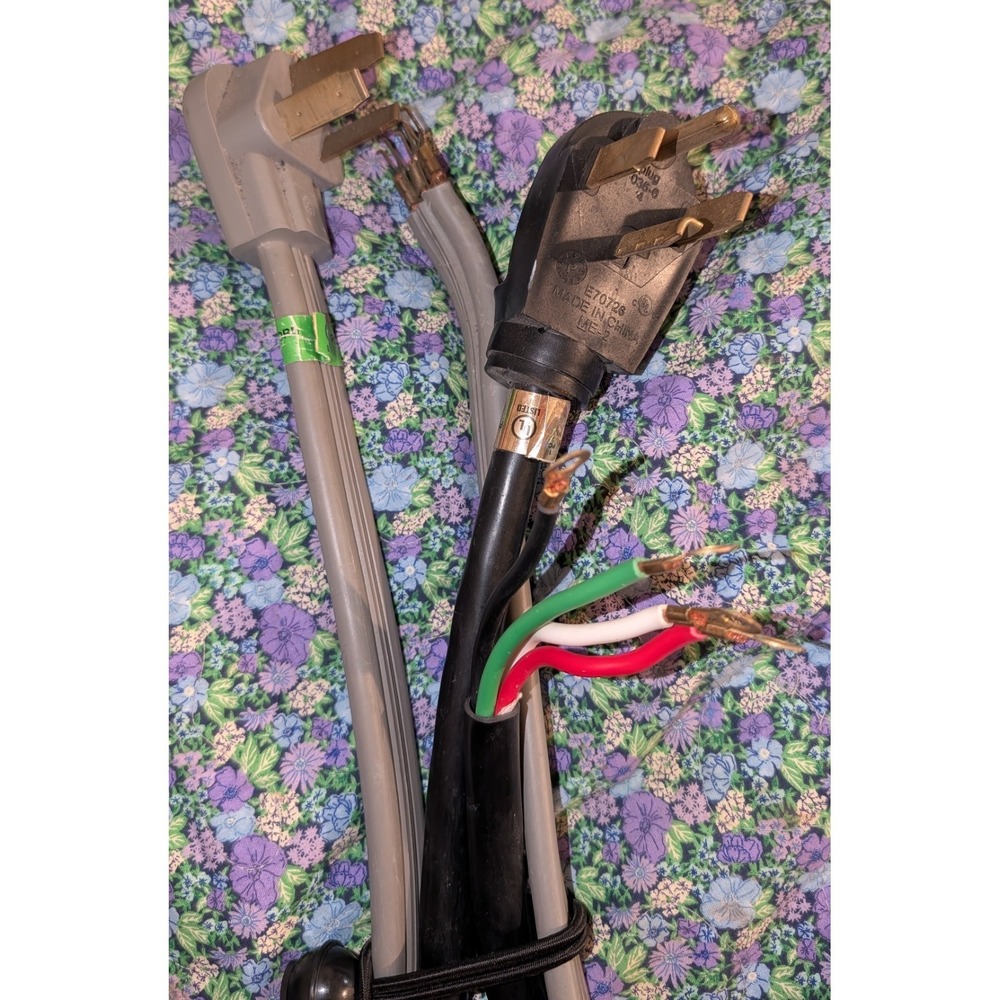 2- 3 Prong Dryer Cords In Good Condition. One Grey, One Black.